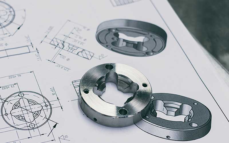 Small metal parts on a blueprint paper